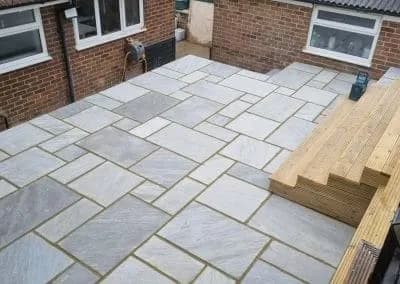 Paved courtyard and timber steps seen from above