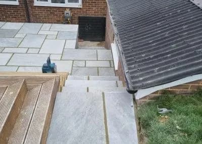 Paved path stepping down beside new decking
