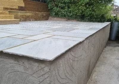 Sandstone paving laid over a rendered raised terrace